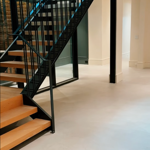 Light burnished microcement floor with warm neutral tone